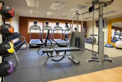 a gym with several treadmills and exercise bikes at DoubleTree by Hilton Denver/Westminister in Westminster