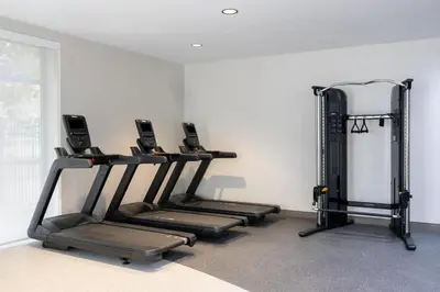 a gym with three treadmills in a room at Hilton Garden Inn Denver Tech Center in Denver
