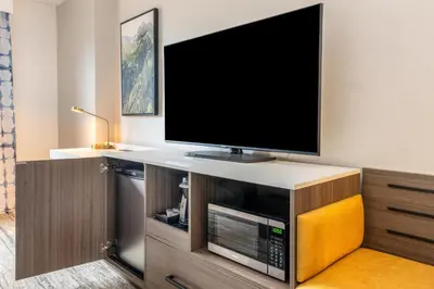 a flat screen tv sitting on top of a entertainment center at Hilton Garden Inn Denver Tech Center in Denver