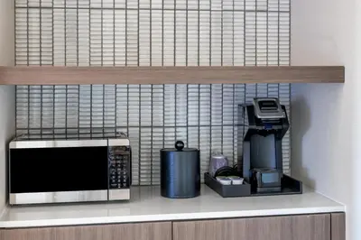 a kitchen shelf with a microwave and a coffee maker at Hilton Garden Inn Denver Tech Center in Denver
