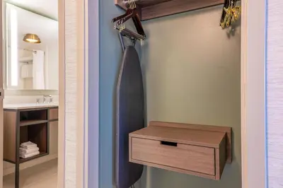 a bathroom with a shower curtain and a wooden drawer at Hilton Garden Inn Denver Tech Center in Denver