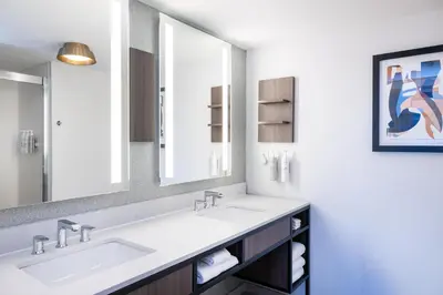 a bathroom with two sinks and a large mirror at Hilton Garden Inn Denver Tech Center in Denver