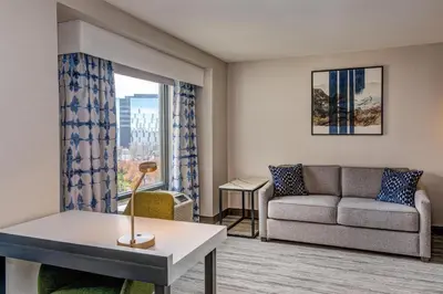 a living room with a couch and a window at Hilton Garden Inn Denver Tech Center in Denver