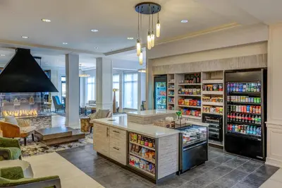 a large room with a grocery store with drinks at Hilton Garden Inn Denver Tech Center in Denver