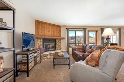 a living room with a couch and a fireplace at Salt Lick #4812 - Wildernest in Silverthorne