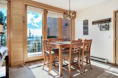 a dining room with a table and chairs and a window at Timber Ridge #410 - Wildernest in Silverthorne