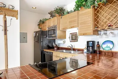 a kitchen with wooden cabinets and a counter top at Timber Ridge #410 - Wildernest in Silverthorne
