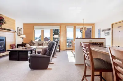 a living room with a couch and a table and chairs at Timber Ridge #410 - Wildernest in Silverthorne