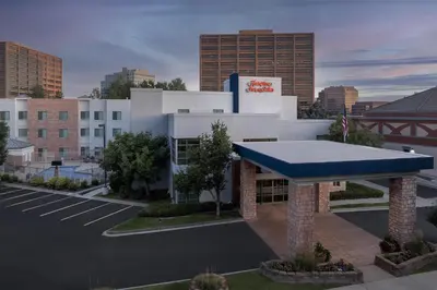a building with a blue awning in a parking lot at Hampton Inn & Suites Denver Tech Center in Centennial