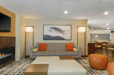 a living room with a couch and a tv at Hampton Inn & Suites Denver Tech Center in Centennial
