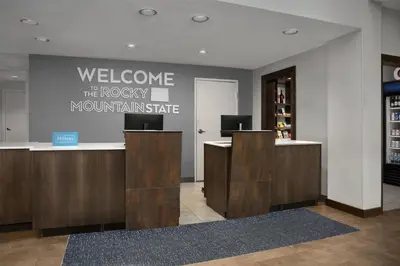 a lobby with a welcome sign on the wall at Hampton Inn & Suites Denver Tech Center in Centennial