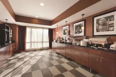 a large kitchen with brown cabinets and a checkered floor at Hampton Inn Denver - Northwest Westminster in Westminster