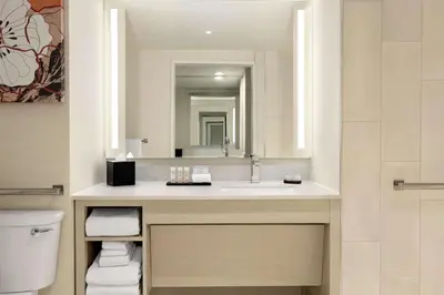 a bathroom with a sink and a mirror at Embassy Suites by Hilton Denver International Airport in Denver
