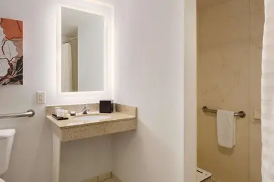 a bathroom with a sink and a mirror at Embassy Suites by Hilton Denver International Airport in Denver