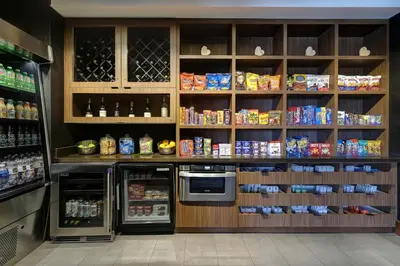 a store with a refrigerator and shelves with food at Courtyard by Marriott Loveland Fort Collins in Loveland