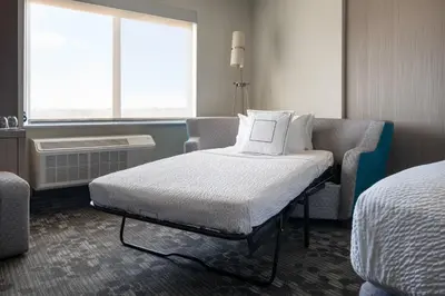 a hospital room with a bed and a window at Courtyard by Marriott Loveland Fort Collins in Loveland