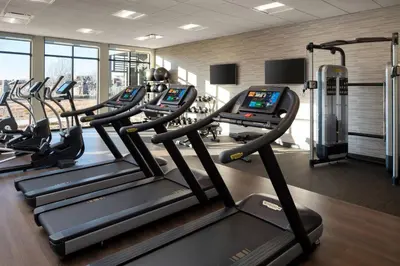 a gym with treadmills and elliptical machines at Courtyard by Marriott Loveland Fort Collins in Loveland