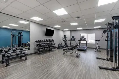 a gym with several treadmills and exercise equipment at Hampton Inn Fort Collins in Fort Collins