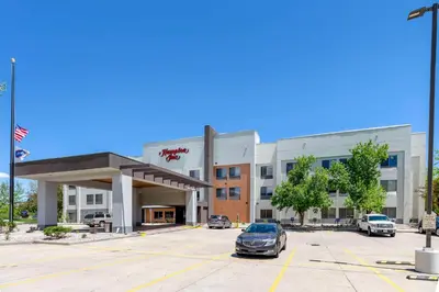 a car parked in a parking lot in front of a building at Hampton Inn Fort Collins in Fort Collins