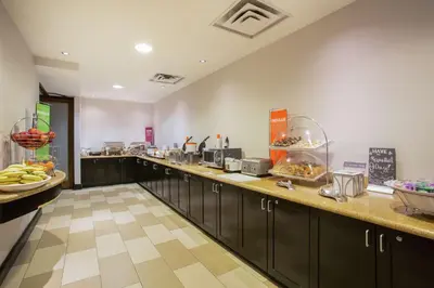 a kitchen with a long counter with aasteryasteryasteryasteryasteryasteryasteryastery at Hampton Inn & Suites Denver-Downtown in Denver