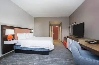 a hotel room with a bed and a flat screen tv at Hampton Inn & Suites Denver-Downtown in Denver