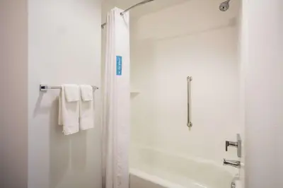 a white bathroom with a shower and a tub at Hampton Inn & Suites Denver-Downtown in Denver