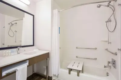 a bathroom with a sink and a tub and a toilet and a shower at Hampton Inn & Suites Denver-Downtown in Denver