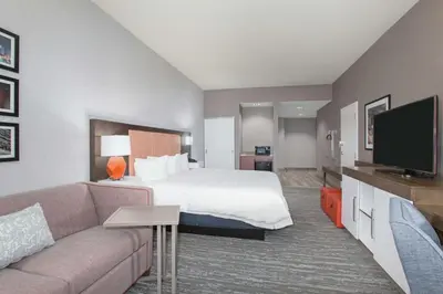 a hotel room with a bed and a couch at Hampton Inn & Suites Denver-Downtown in Denver