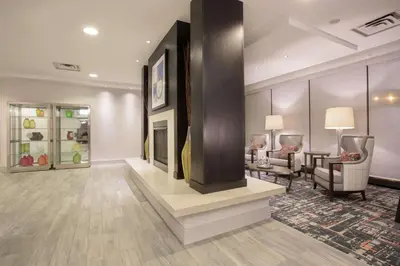 a lobby with a living room with a fireplace at Hampton Inn & Suites Denver-Downtown in Denver