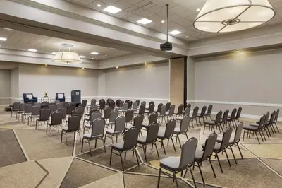 a room with rows of chairs and a projection screen at Hilton Fort Collins in Fort Collins