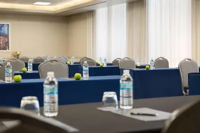 a meeting room with blue tables and bottles of water at Hilton Fort Collins in Fort Collins