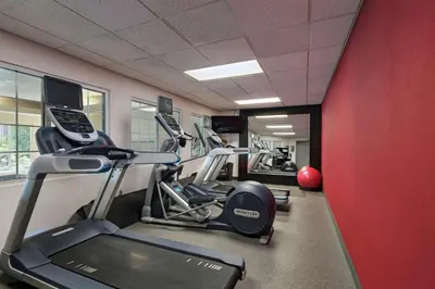 a gym with treadmills and elliptical machines at Homewood Suites by Hilton Fort Collins in Fort Collins
