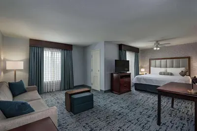 a hotel room with a bed and a couch at Homewood Suites by Hilton Fort Collins in Fort Collins