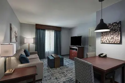 a living room with a couch and a table in a room at Homewood Suites by Hilton Fort Collins in Fort Collins