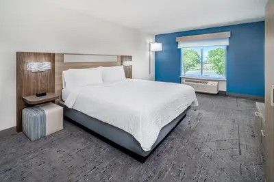 a bedroom with a large bed and a window at Holiday Inn Express & Suites Denver North - Thornton by IHG in Thornton