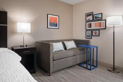 a living room with a couch and a table at Hampton Inn Boulder/Louisville in Louisville
