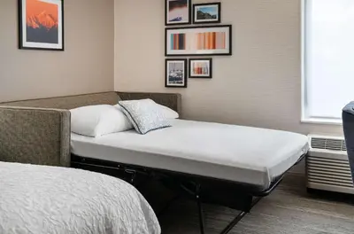 a hospital room with two beds and a window at Hampton Inn Boulder/Louisville in Louisville