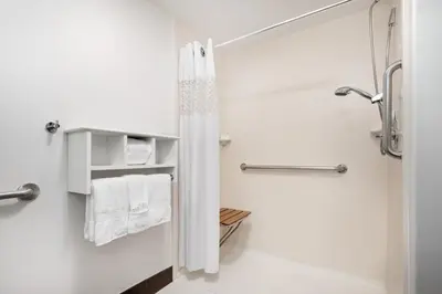 a white bathroom with a shower and a toilet at Hampton Inn Boulder/Louisville in Louisville
