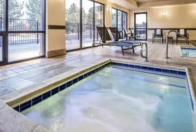 a swimming pool in the middle of a building with a patio at Hampton Inn Boulder/Louisville in Louisville