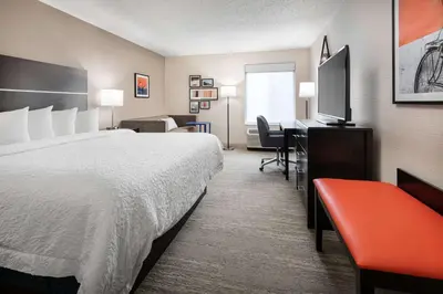 a hotel room with a bed and a desk at Hampton Inn Boulder/Louisville in Louisville