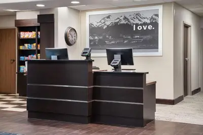 a reception desk in a library with a sign that says love at Hampton Inn Boulder/Louisville in Louisville