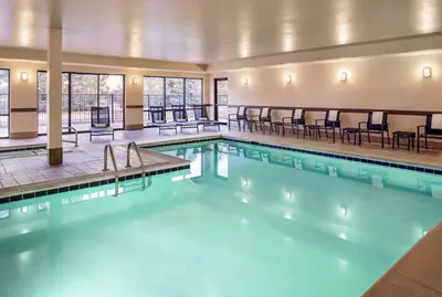 a pool with chairs and tables in a building at Hampton Inn Boulder/Louisville in Louisville