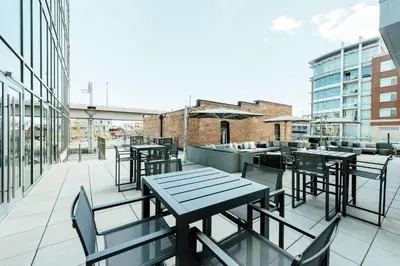 an outdoor patio with tables and chairs on a building at Hilton Garden Inn Denver Union Station in Denver