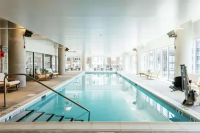a large pool with blue water in a building at Hilton Garden Inn Denver Union Station in Denver
