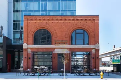 a red brick building with windows and tables and a fire hydrant at Hilton Garden Inn Denver Union Station in Denver