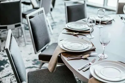 a table with plates and wine glasses on it at Hilton Garden Inn Denver Union Station in Denver