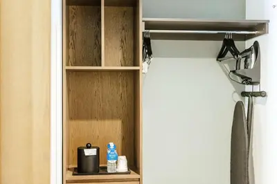 a closet with a wooden shelf in a bathroom at Hilton Garden Inn Denver Union Station in Denver
