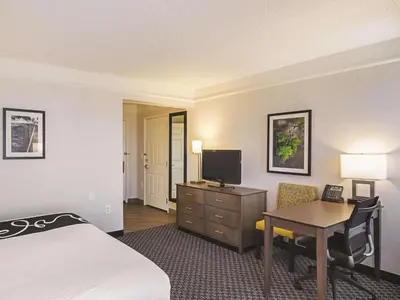 a hotel room with a bed and a desk and a television at La Quinta by Wyndham Denver Tech Center in Greenwood Village