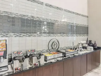 a kitchen with several trays of food on a counter at La Quinta by Wyndham Denver Tech Center in Greenwood Village