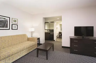 a living room with a couch and a flat screen tv at La Quinta by Wyndham Denver Englewood Tech Ctr in Greenwood Village
